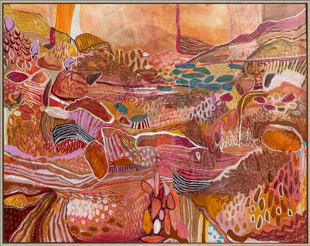 An abstract landscape painting featuring organic, layered terrain in warm earthy tones of orange, brown, pink, and beige, enclosed in a thin oak frame. JWG artwork