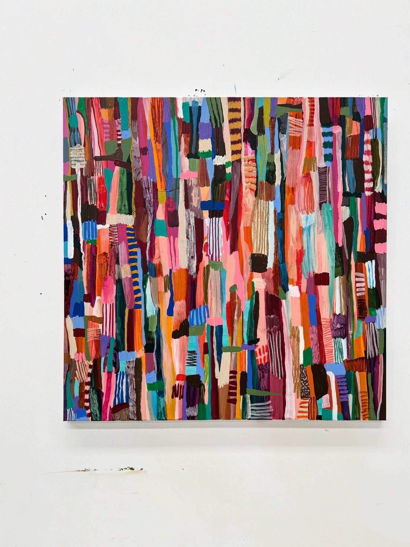 Colorful abstract art piece on a white wall