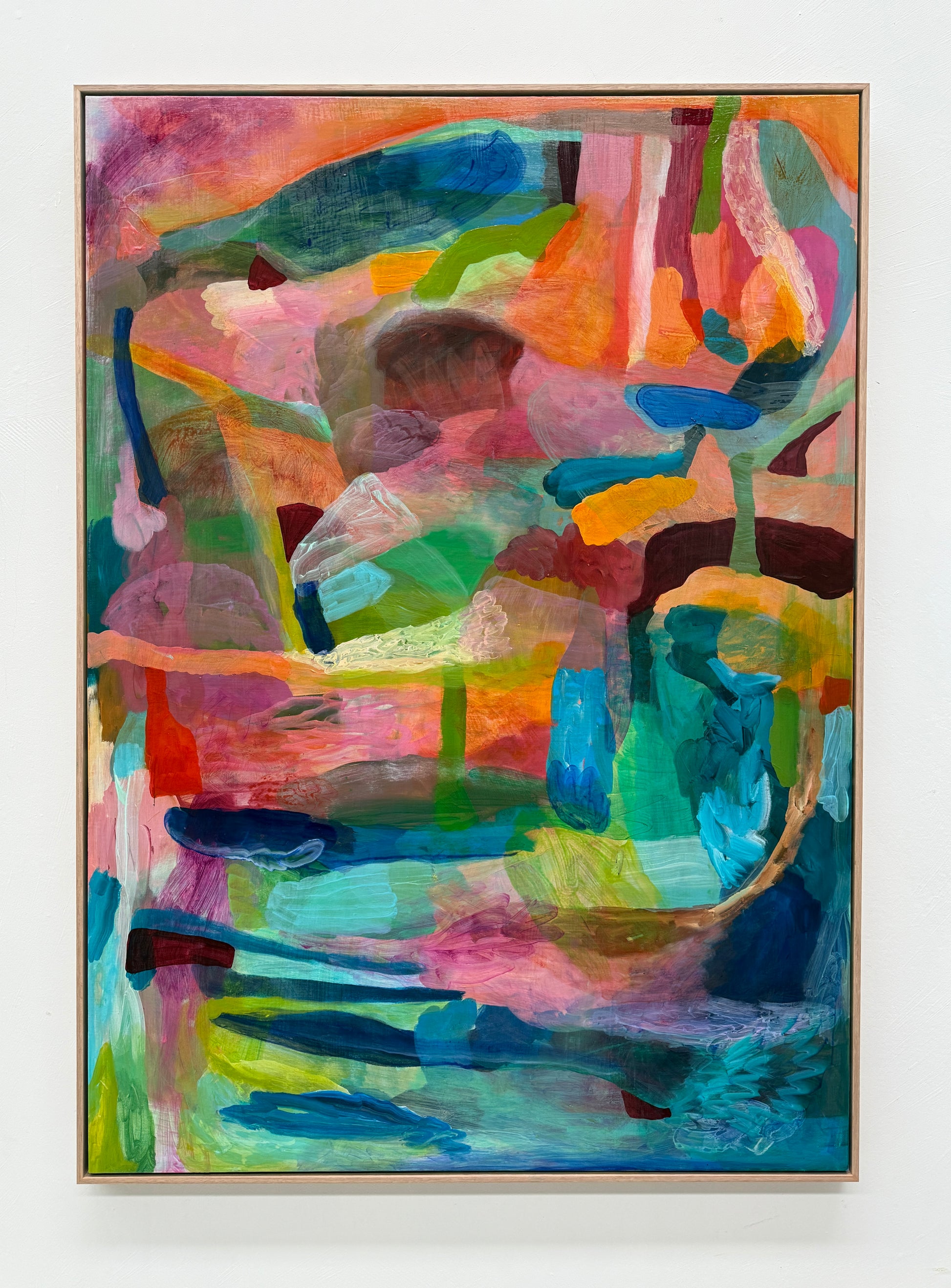 Colorful abstract painting with vibrant hues on a white wall