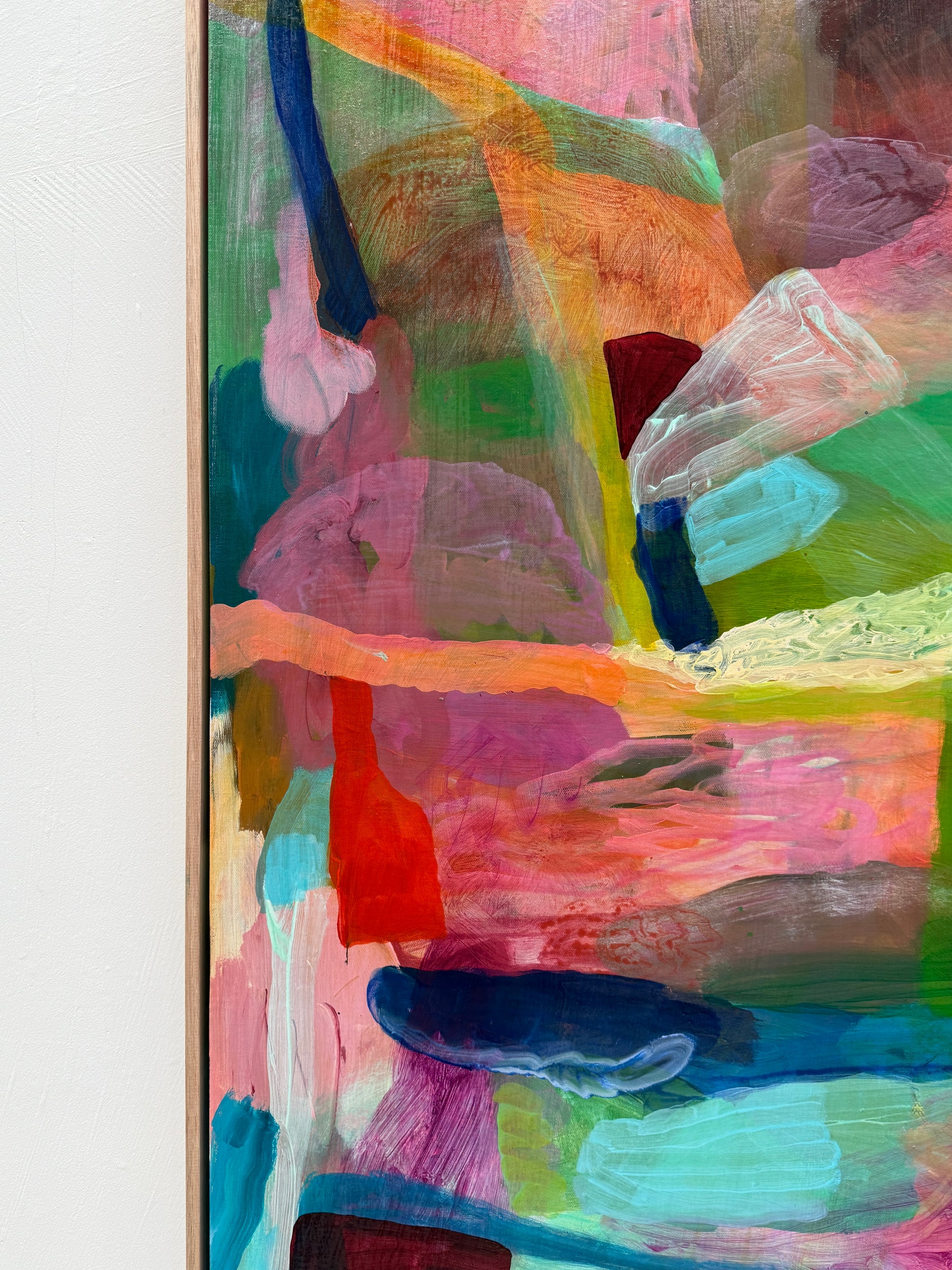 Abstract painting with vibrant colors on a white wall