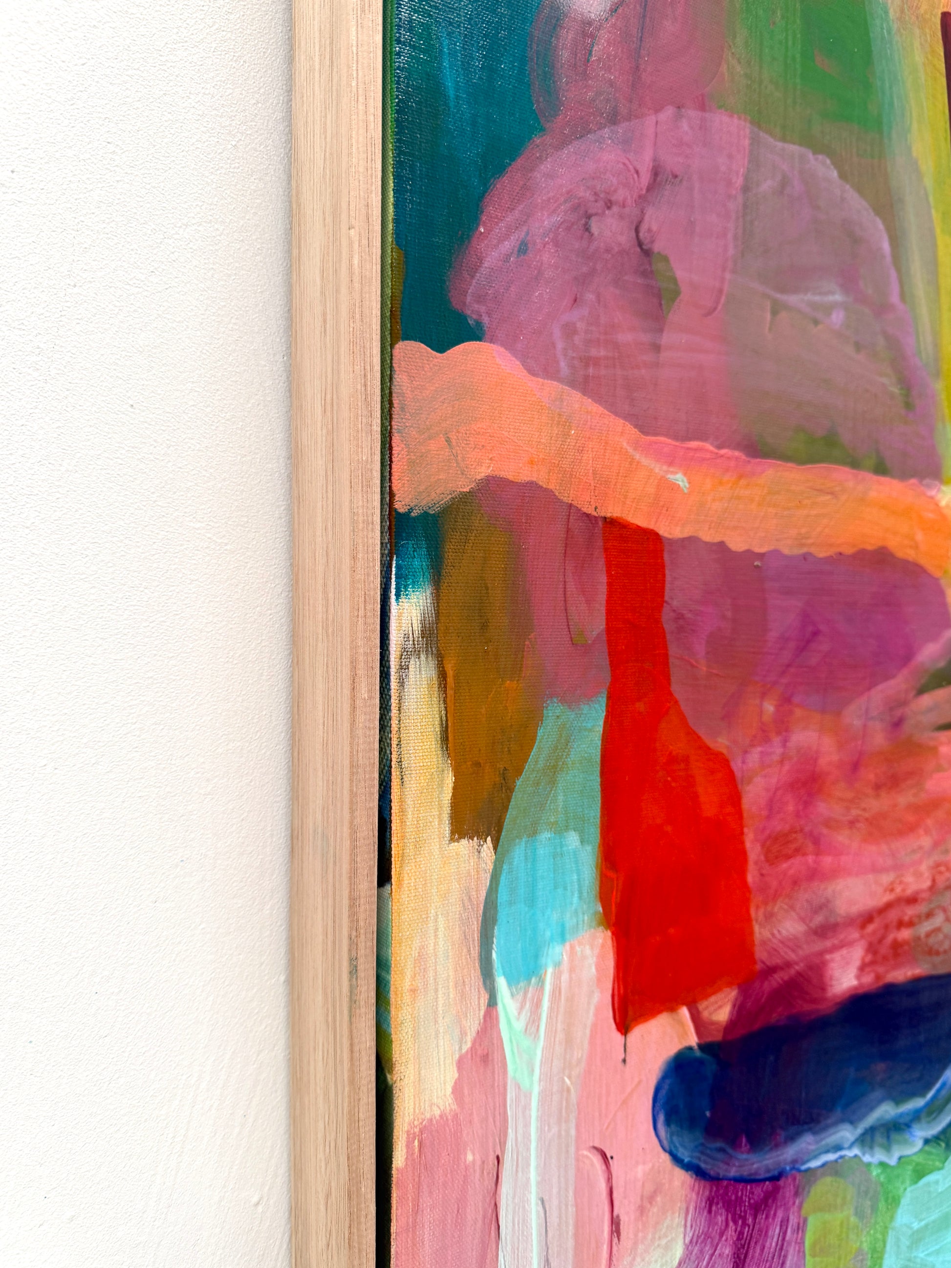 Close-up of a colorful abstract painting with vibrant brush strokes on a white background.