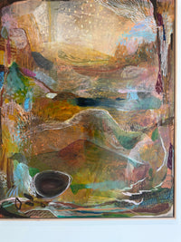 Abstract painting with a variety of colors and shapes on a white wall.