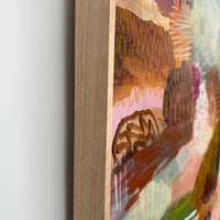 Close-up of a painting with abstract designs on a white wall